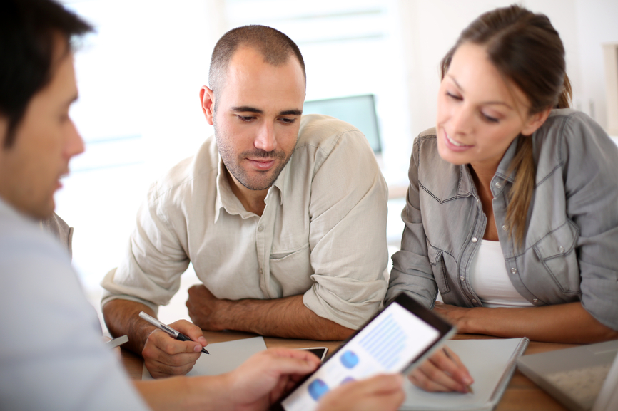 Manager with sales people presenting budget